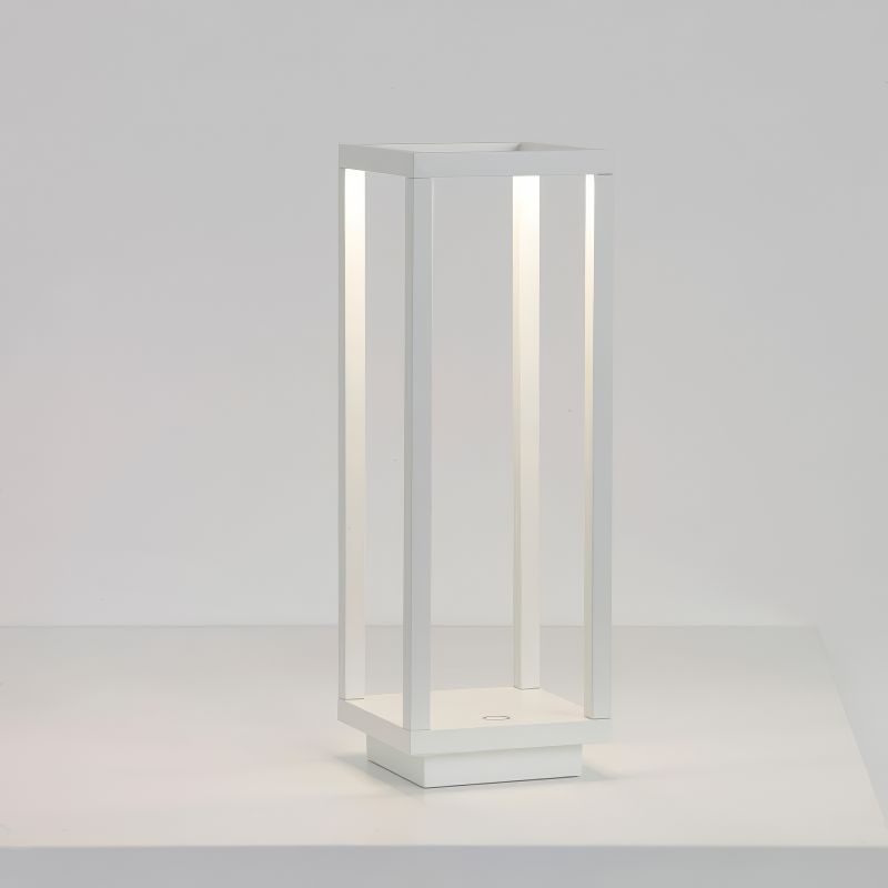 Sleek modern white LED lantern with a minimalist open-frame design, featuring soft, ambient lighting. This cordless and rechargeable lantern is perfect for both indoor and outdoor use, blending contemporary style with functional elegance.