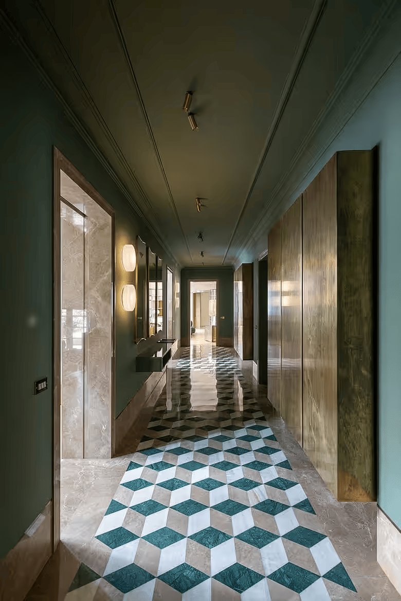 Hallway with geometric marble flooring and soft lighting.