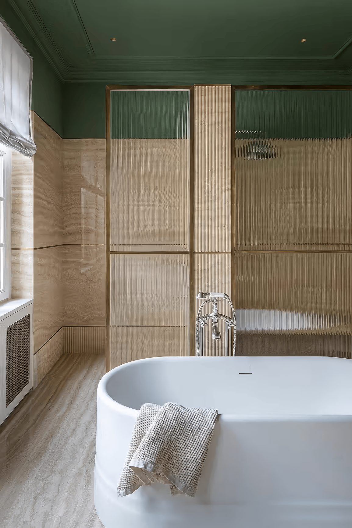 Freestanding white bathtub against fluted glass panels and beige stone walls.
