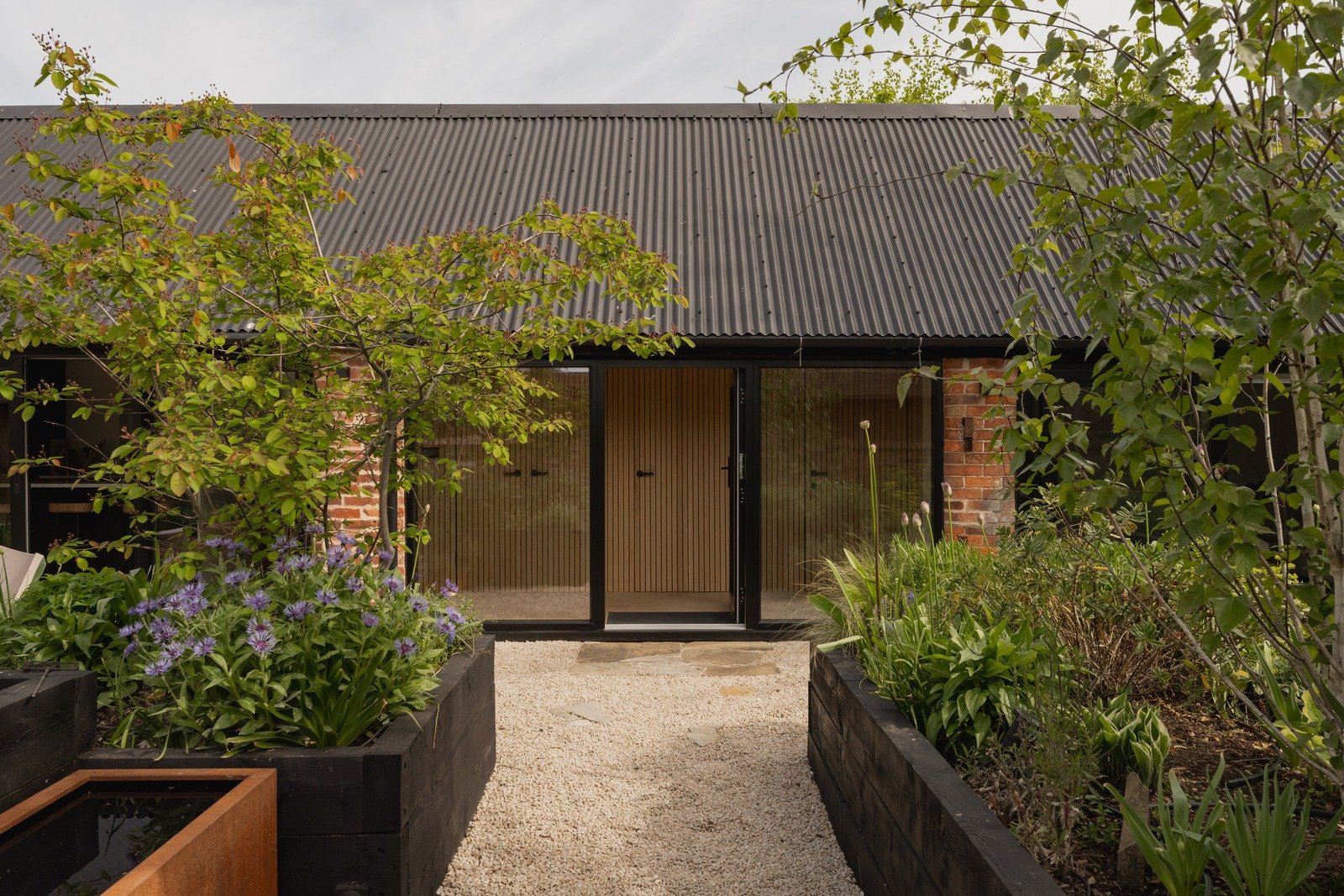 fen-barn-modern-barn-garden-entry-path-with-plants.jpg