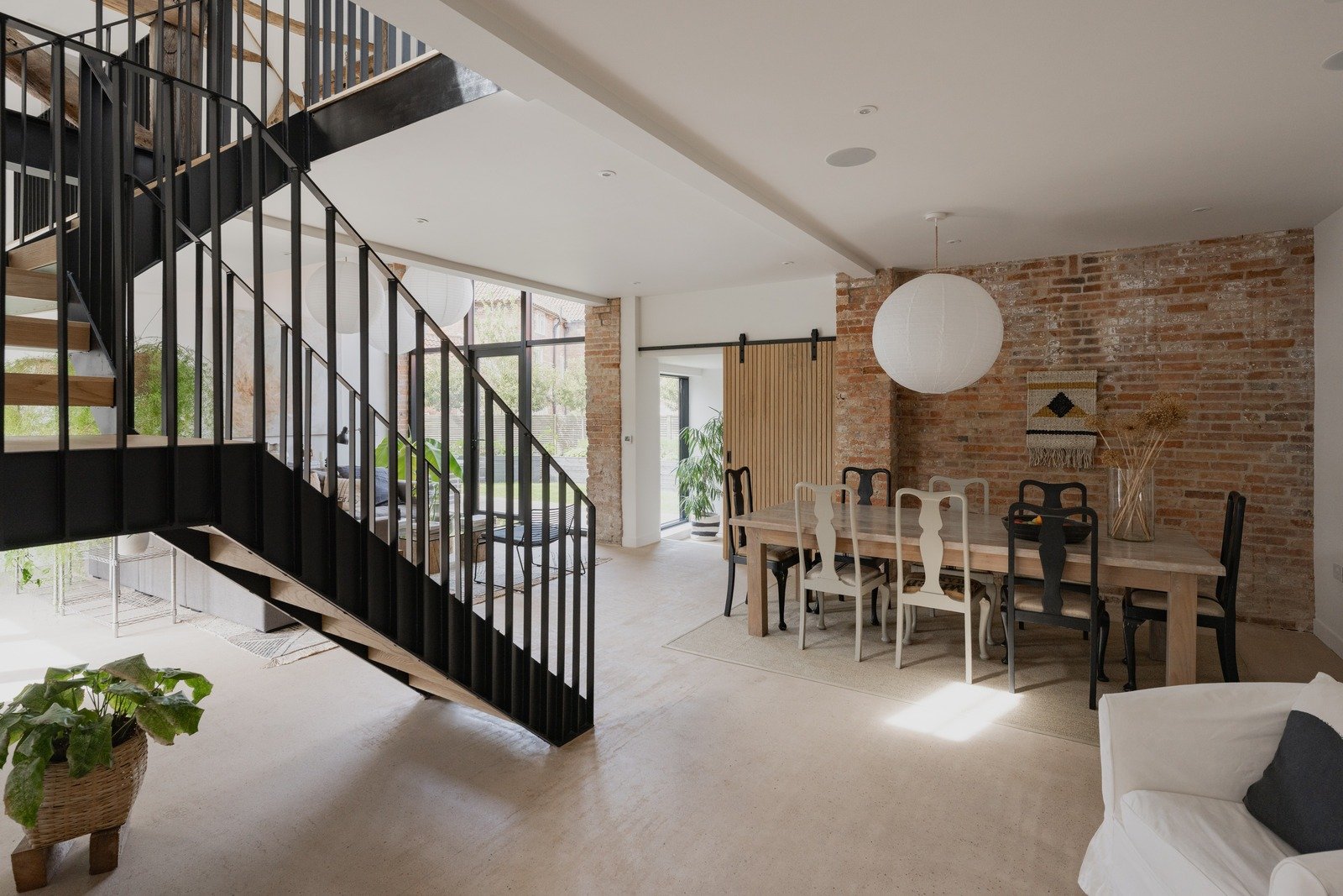 fen-barn-industrial-staircase-open-dining-living-area.jpg