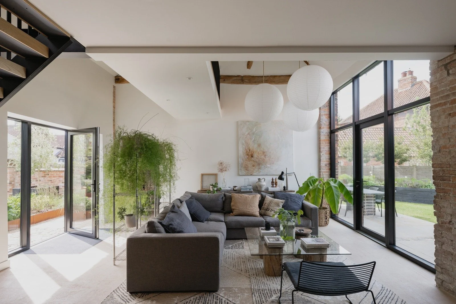 fen-barn-lofted-living-room-with-glass-doors-and-paper-lanterns.jpg