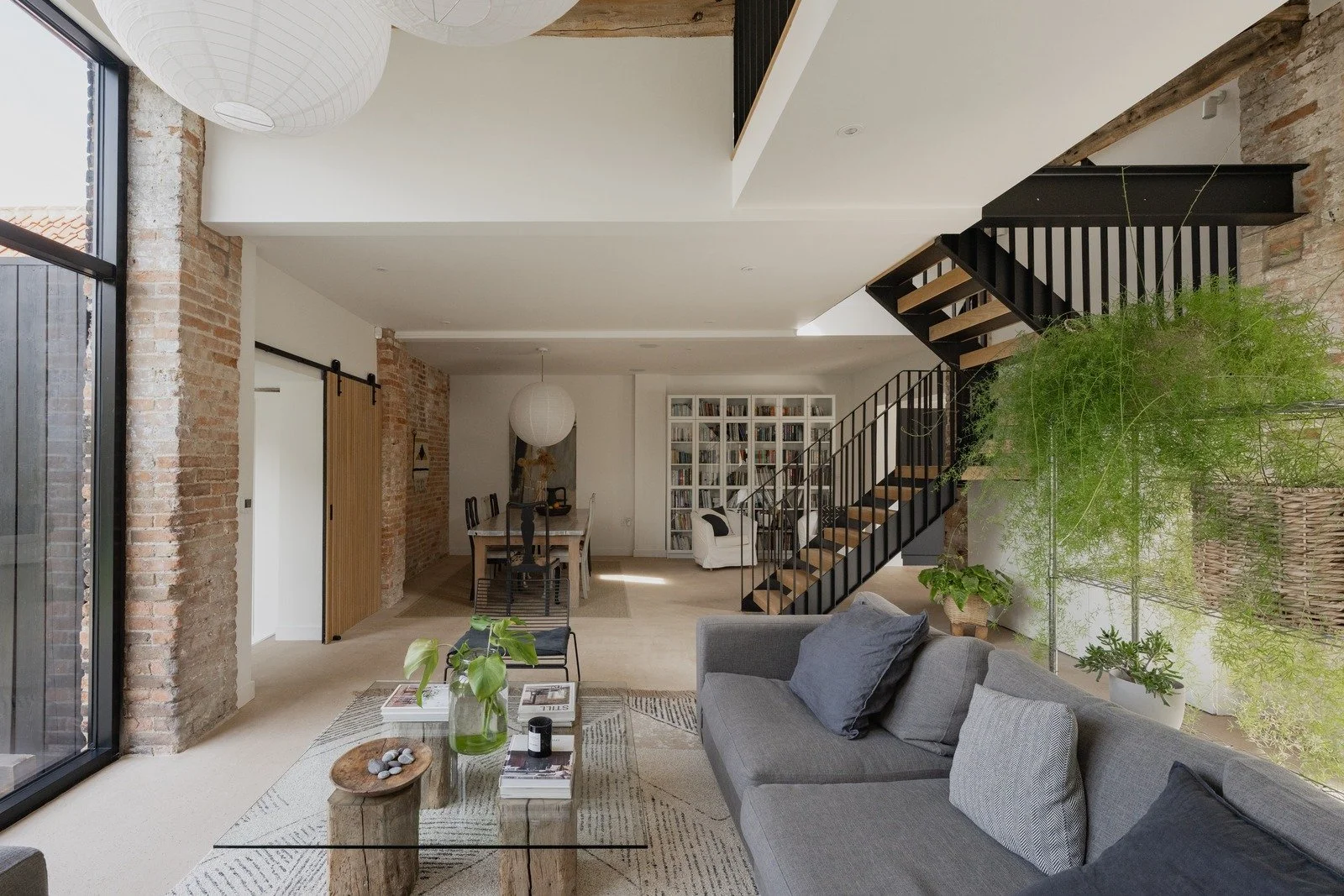 fen-barn-open-plan-living-and-dining-with-metal-staircase.jpg