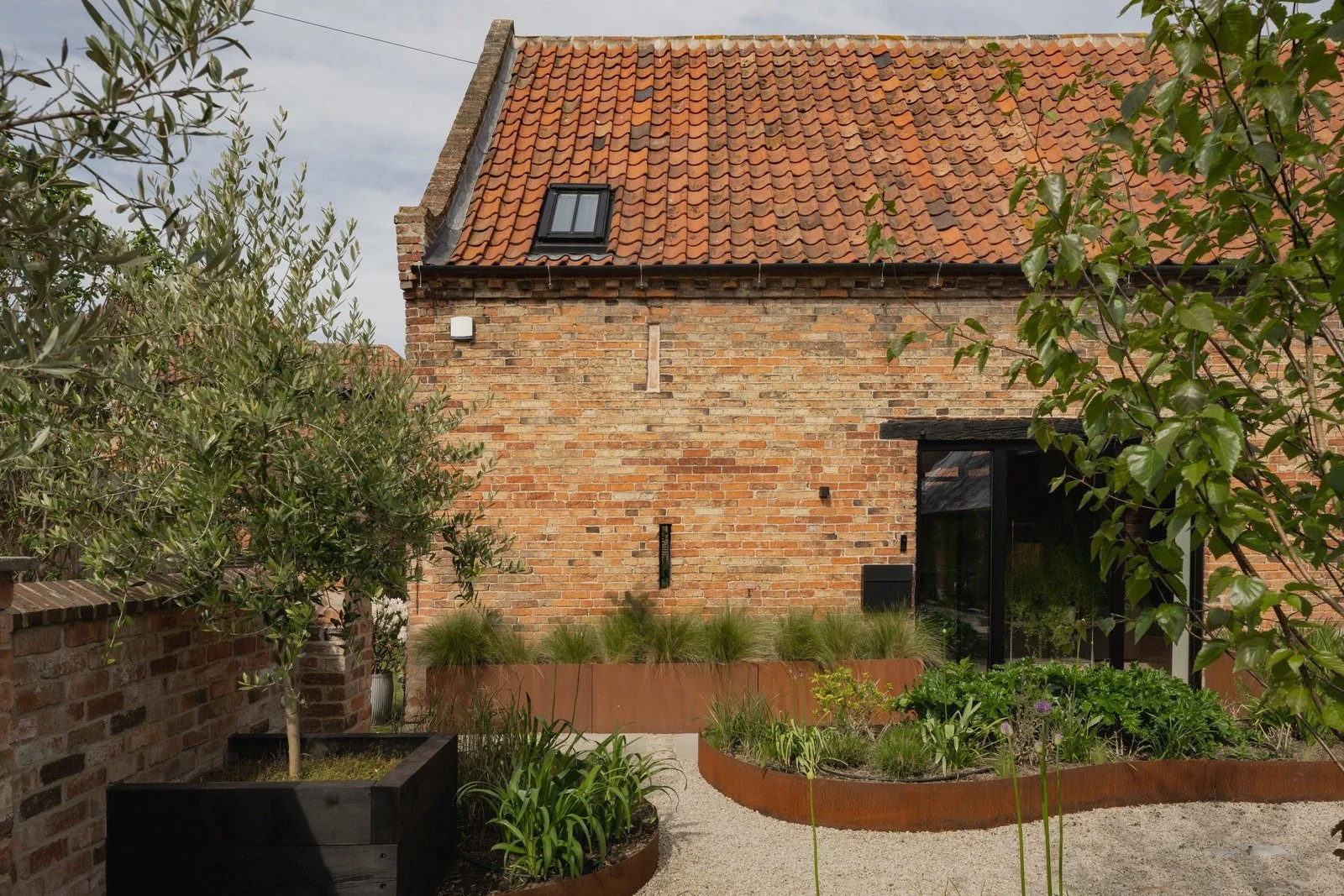 fen-barn-dutch-roof-garden-wall-and-planters.jpg