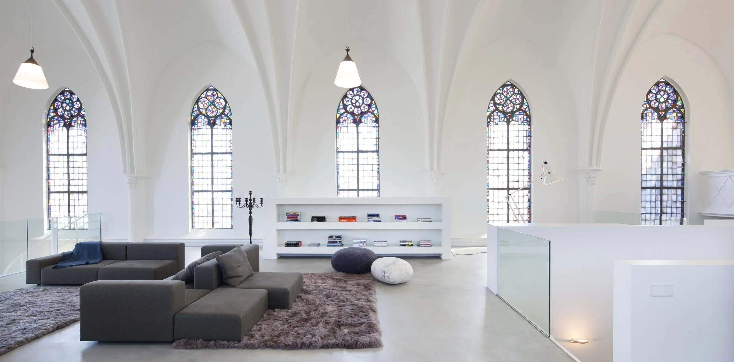 Light-filled church conversion living room with original windows and airy open-plan interiors — sacred meets Scandinavian.