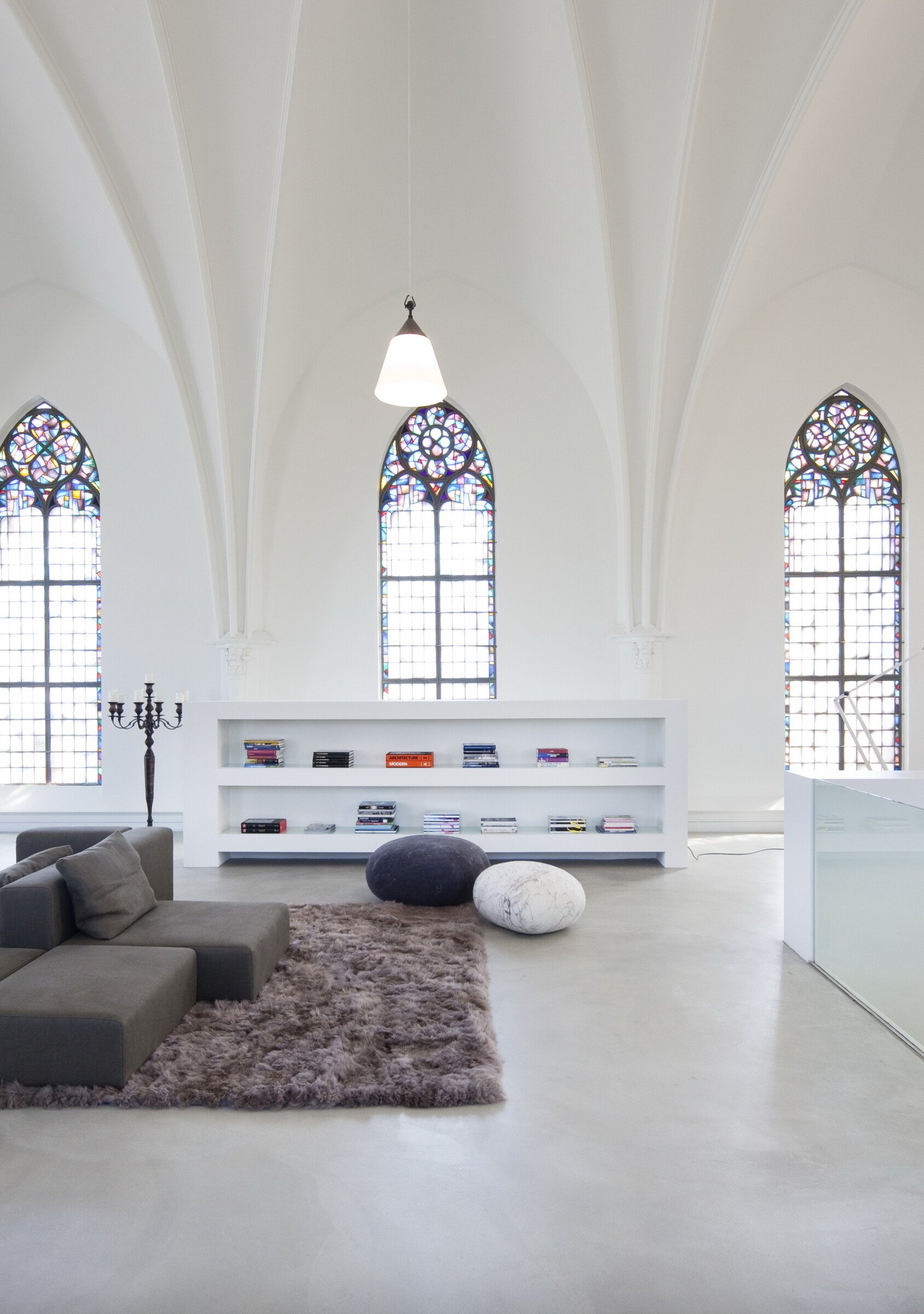 Mezzanine bedroom inside modern church home — clean lines, minimalist design, and preserved Gothic architecture.