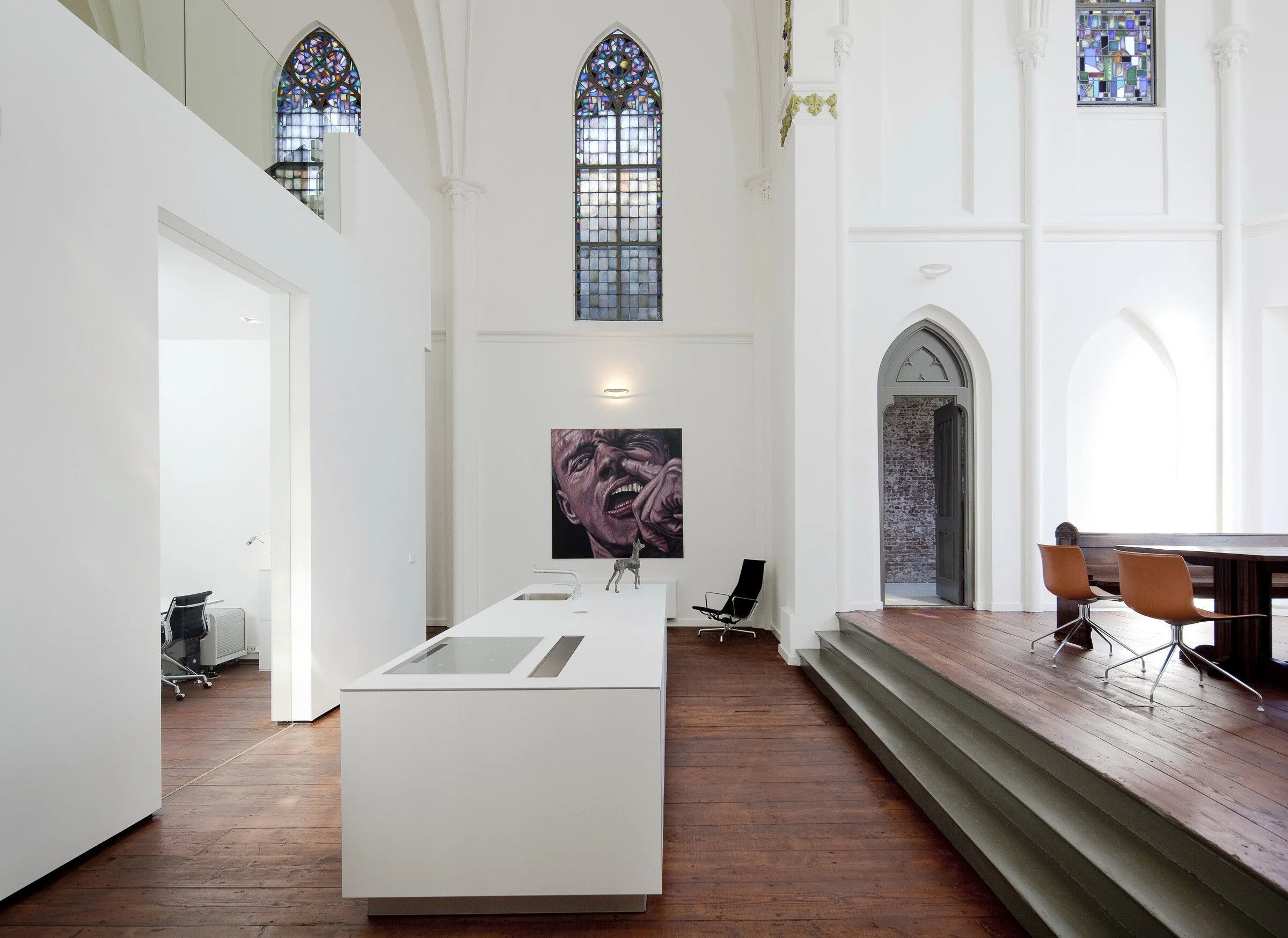 Modern kitchen built inside a freestanding structure within historic Dutch church — a bold twist on adaptive reuse.