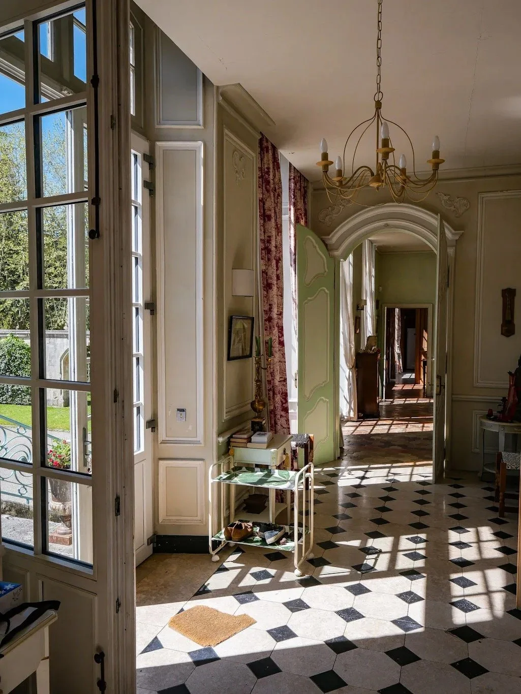 french-chateau-hallway-checkerboard-flooring-natural-light.jpg