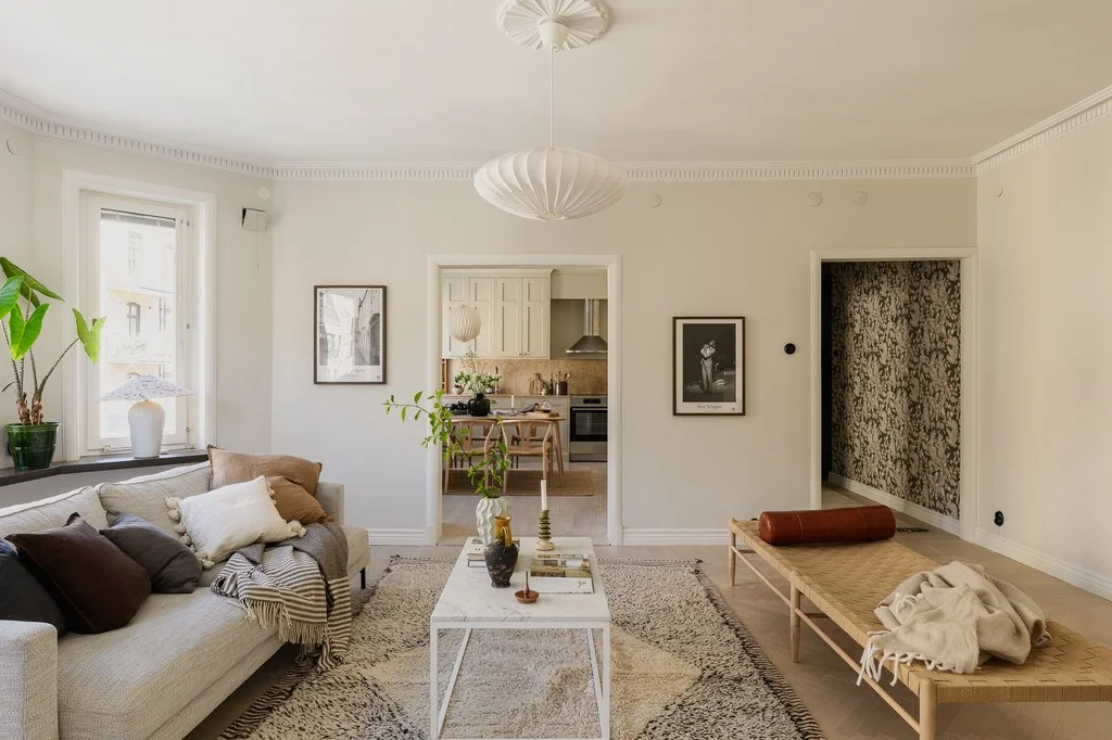 Inviting Scandinavian Living Room with Layered Rugs and Neutral Tones