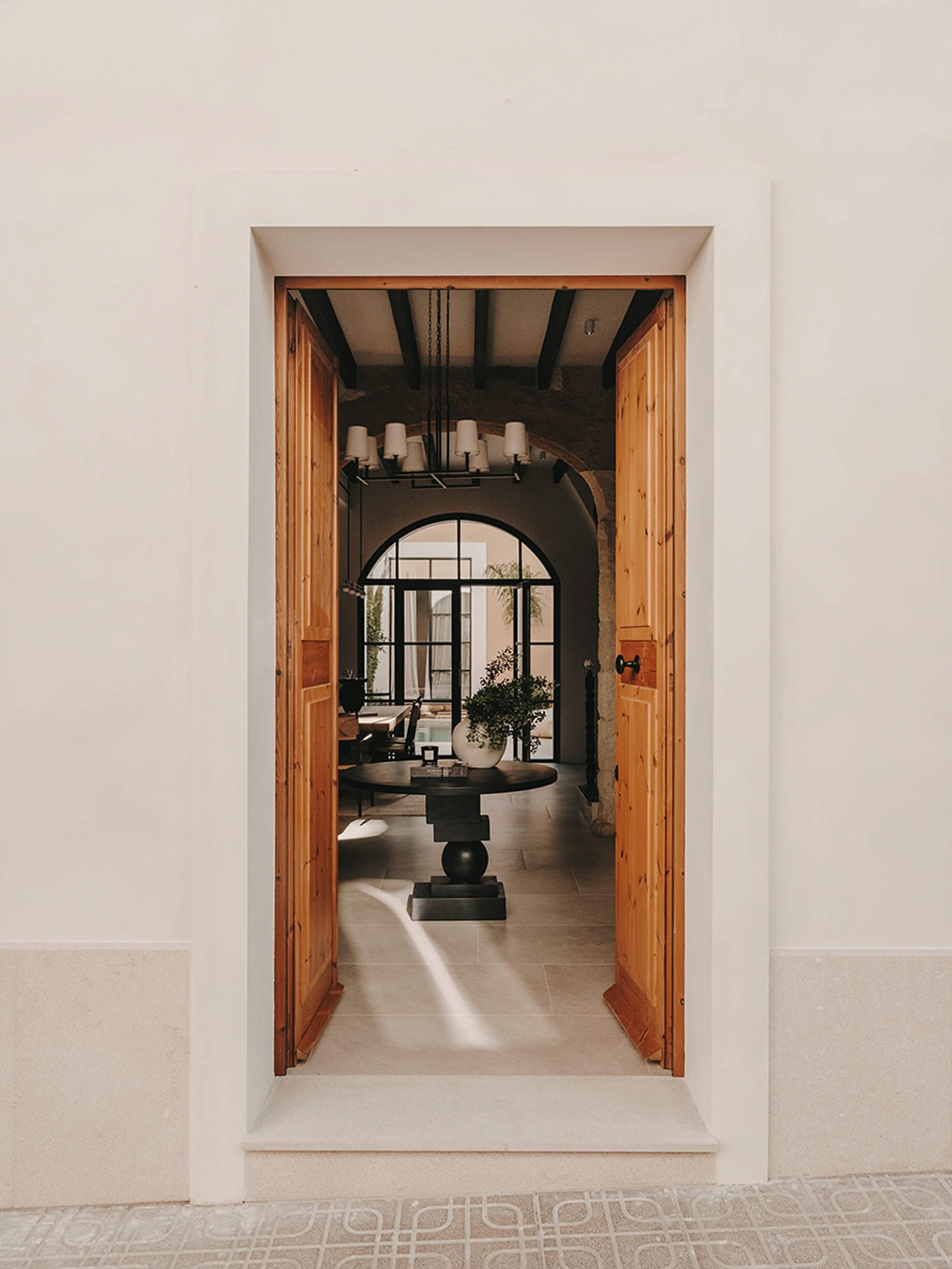 front door entrance to historical townhouse with sight lines straight through to the pool