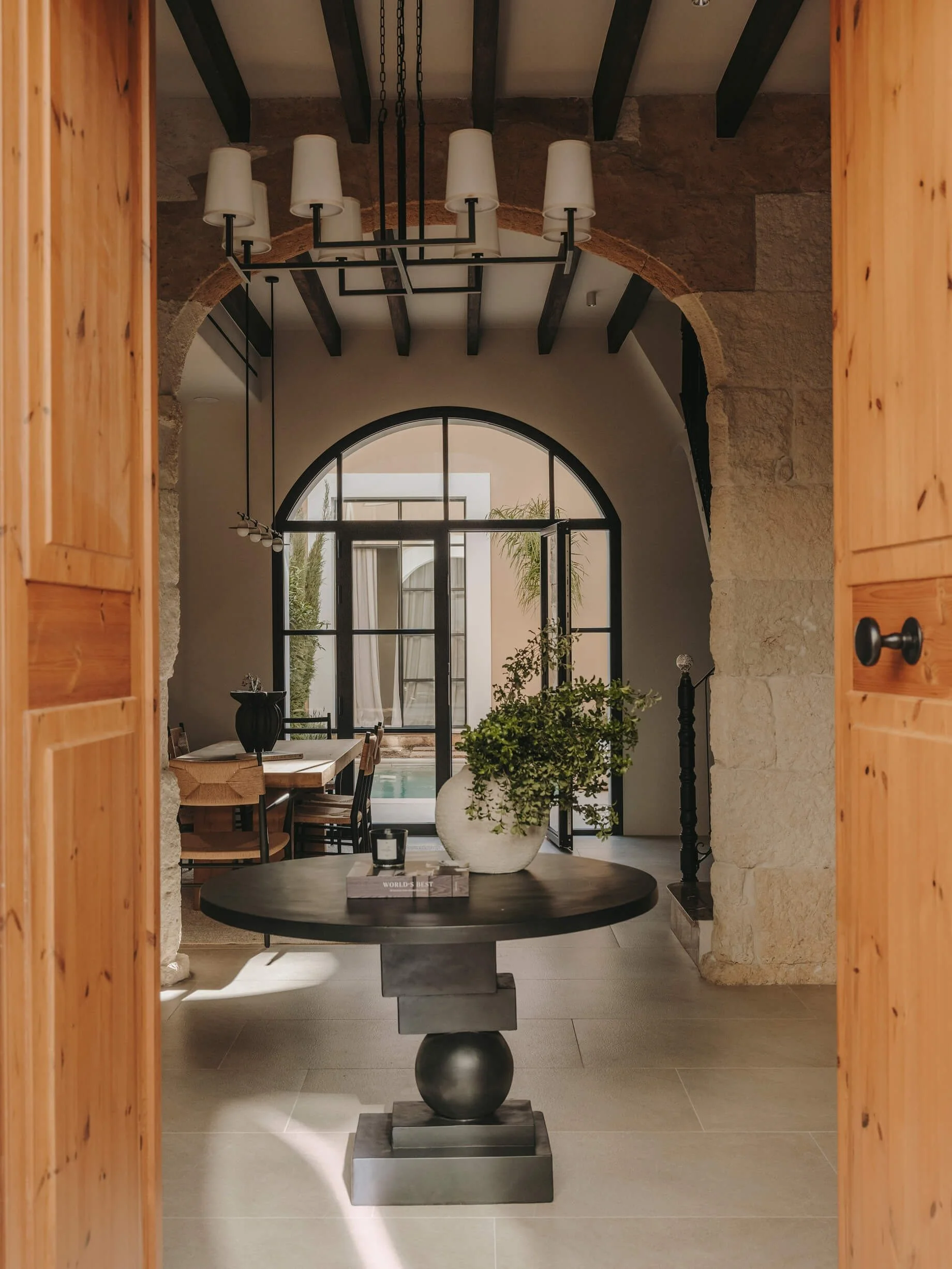 Stunning rustic entryway with beamed ceiling leading into the dining area and straight to the pool.