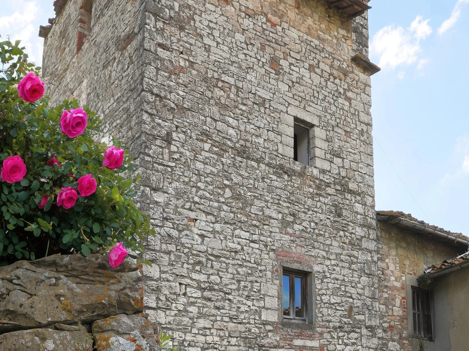 medieval-tower-tuscany-stone-wall-roses.jpg