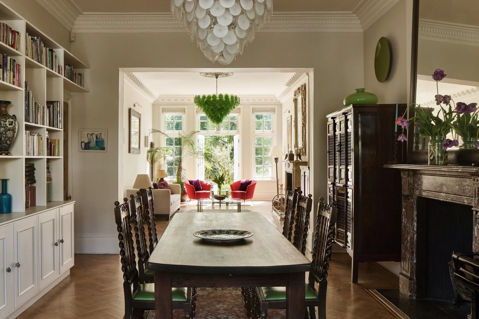 open-plan-dining-and-living-room-with-vintage-furnishings-and-bold-light-fixtures.jpg
