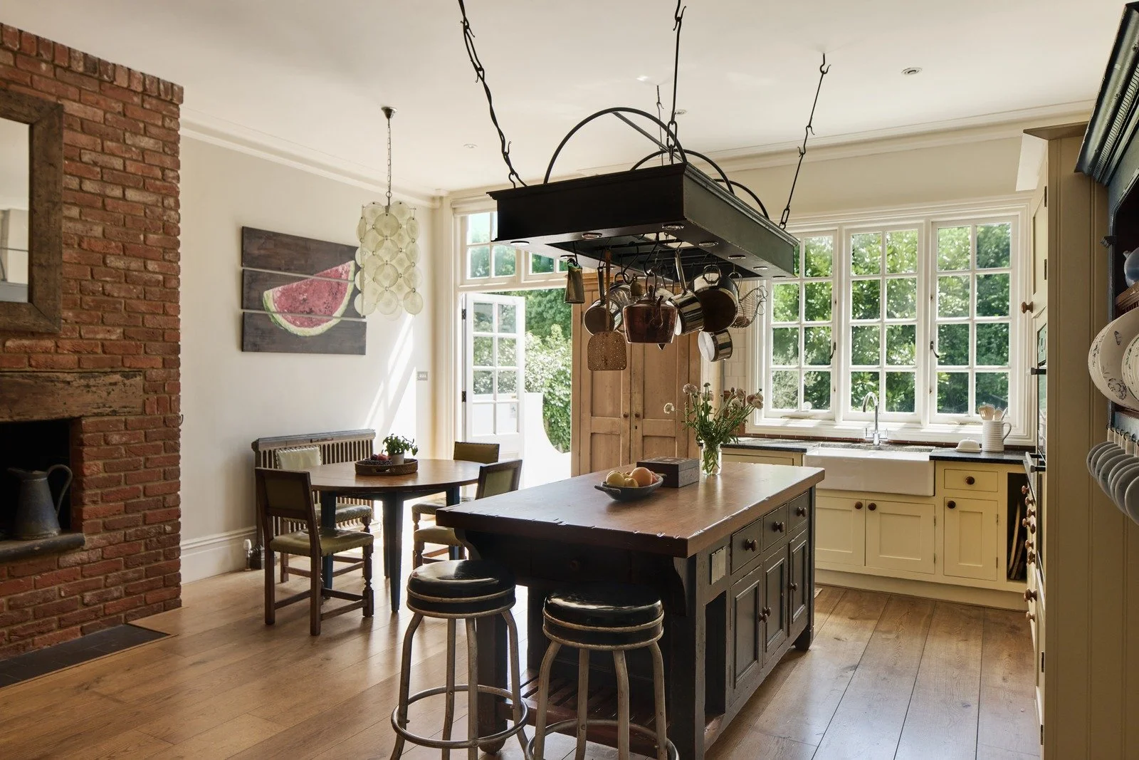 rustic-country-kitchen-with-pot-rack-farmhouse-island-and-brick-fireplace.jpg