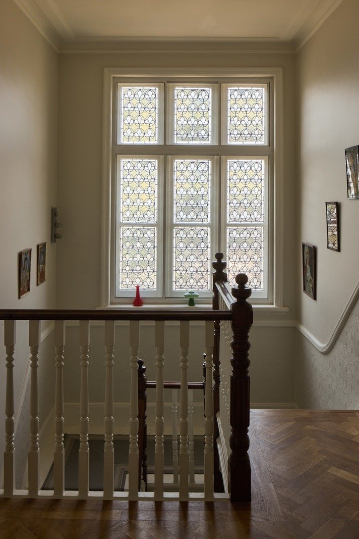 victorian-staircase-landing-with-leaded-glass-windows-london-home.jpg