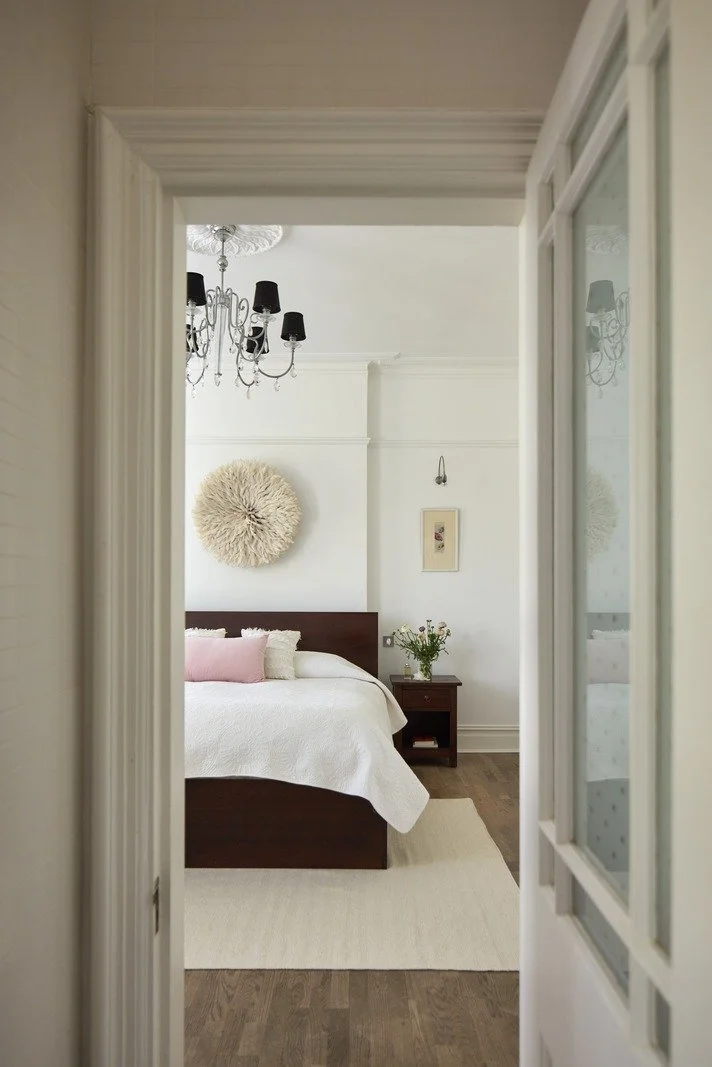 victorian-light-filled-bedroom-with-white-bedding-and-black-chandelier.jpg