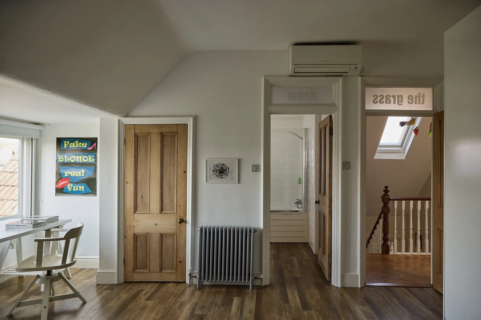 victorian-loft-space-with-playful-poster-and-white-desk.jpg