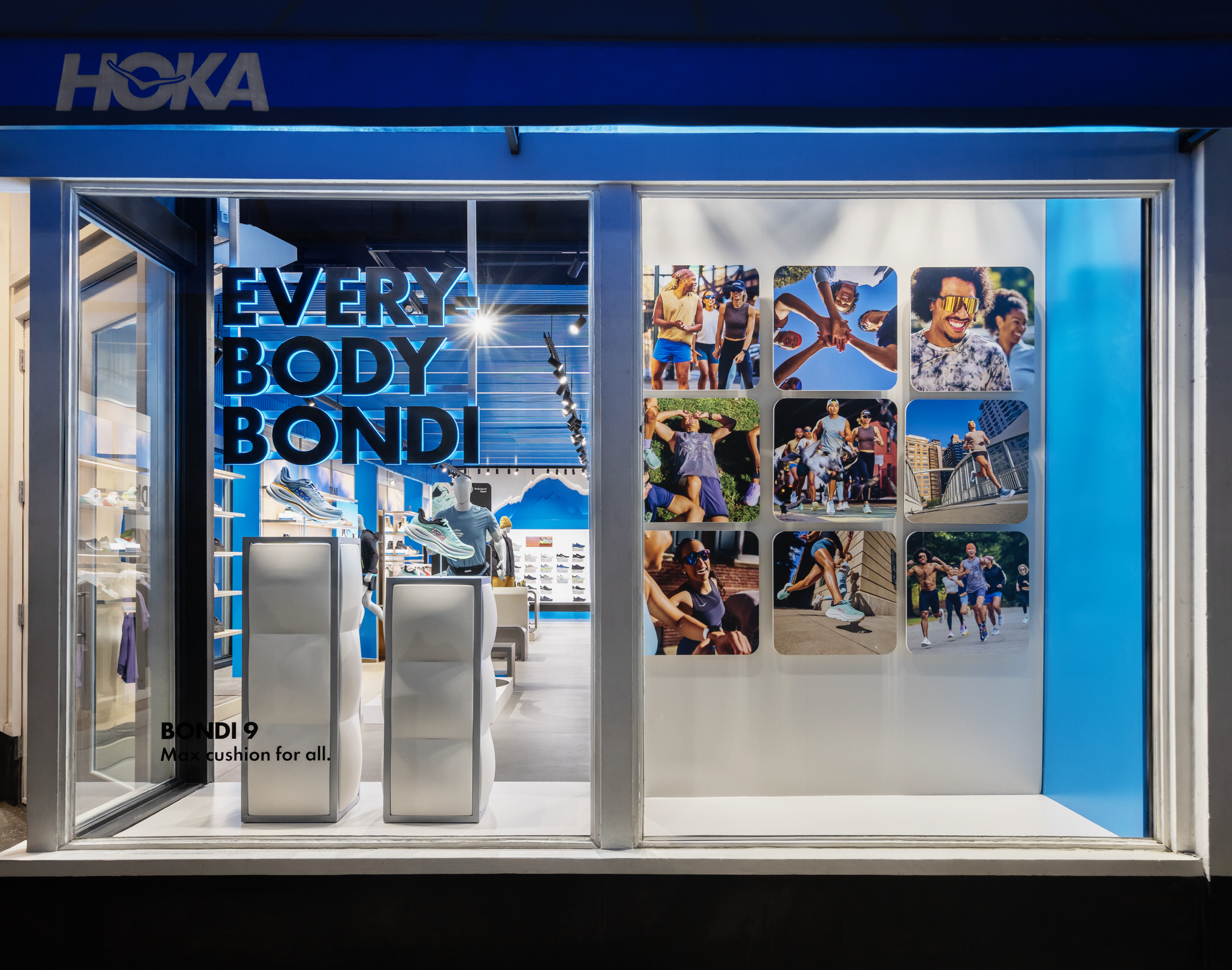 Storefront display with large blue neon sign saying 'EVERYBODY' and photos of diverse people enjoying outdoor activities on the window.