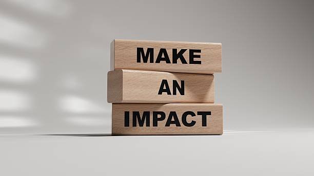 Three wooden blocks stacked with the words 'MAKE', 'AN', and 'IMPACT' printed on the sides.