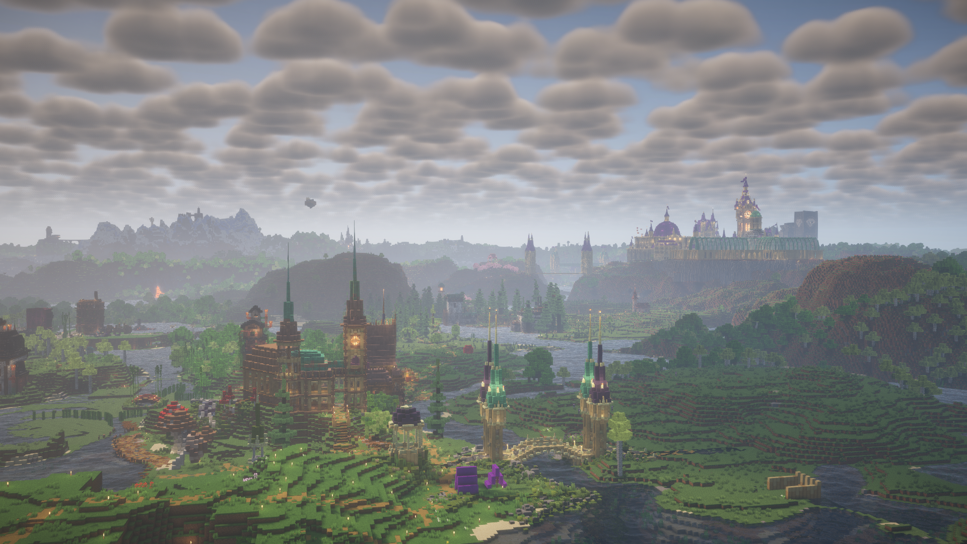 A Minecraft-rendered landscape featuring a castle atop a hill, spires, medieval-style buildings, a river, and mountains in the background under a cloudy sky.