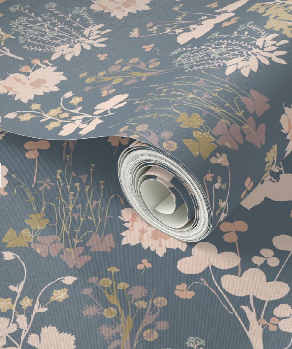 Roll of fabric with a floral pattern in soft pastel colors on a blue background Emily Maria Studios