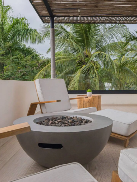Outdoor fire pit lounge with palm tree view at a kosher luxury villa, Dominican Republic