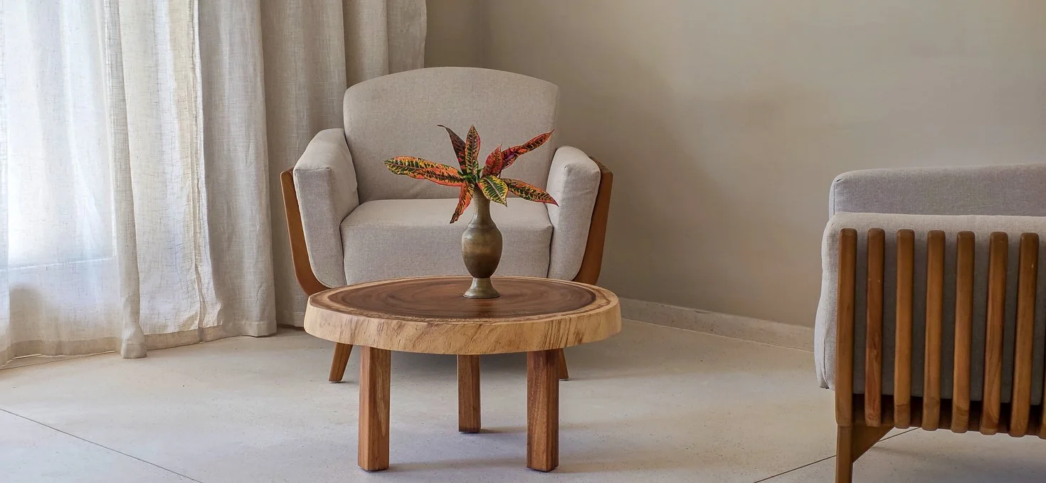 Upholstered armchair beside a round wood side table at a kosher luxury villa, Dominican Republic