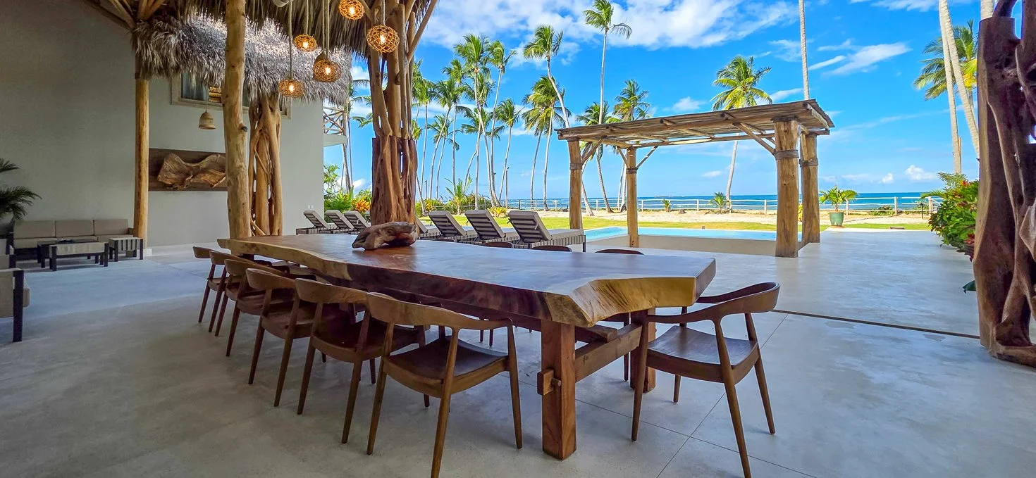 Long outdoor dining table under a pergola with beach and ocean views at a kosher luxury villa, Dominican Republic