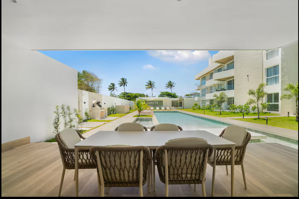 Covered terrace dining area overlooking a modern resort-style pool at a kosher luxury villa, Dominican Republic