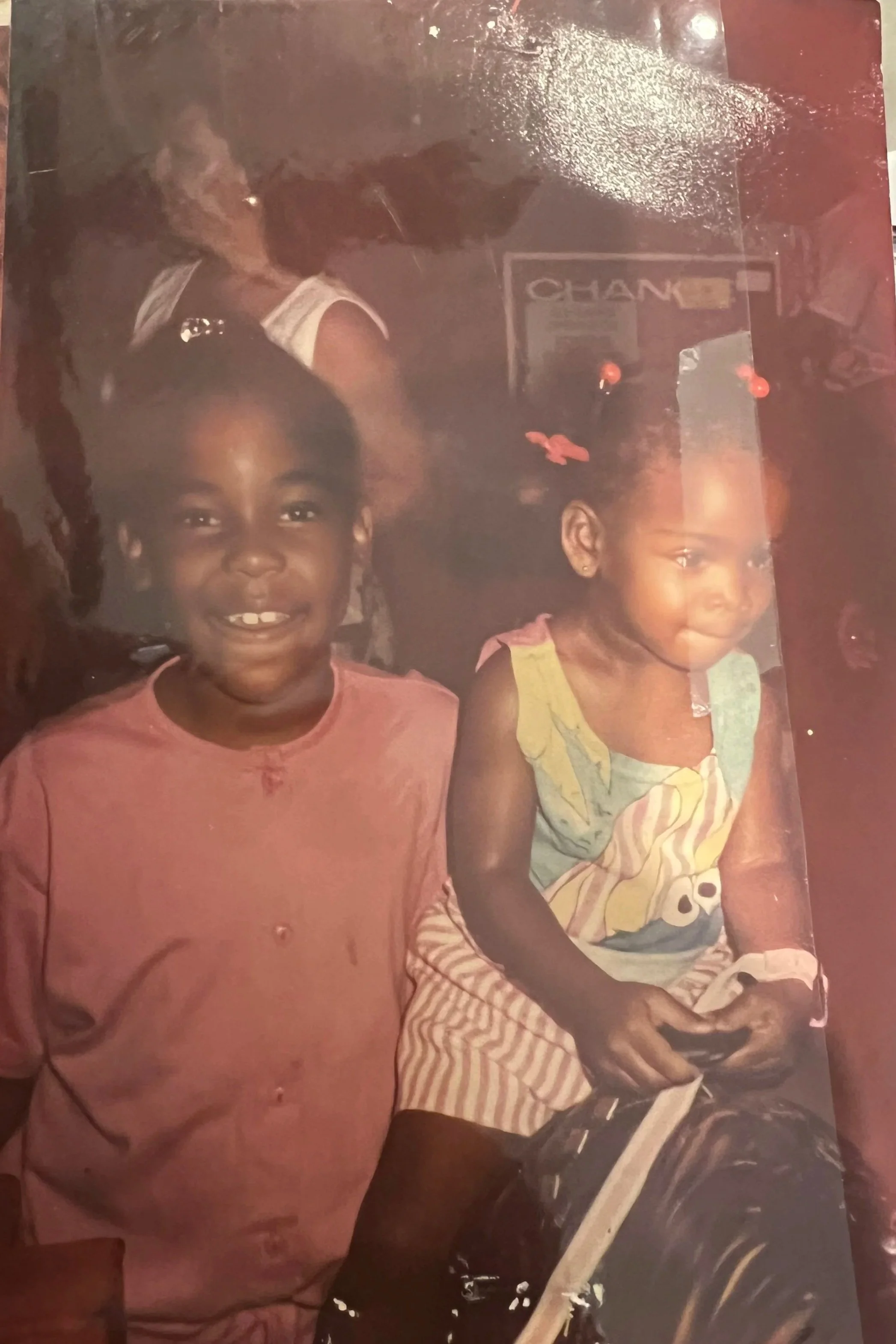 Two family members smiling together during a celebration, preserving a shared memory.