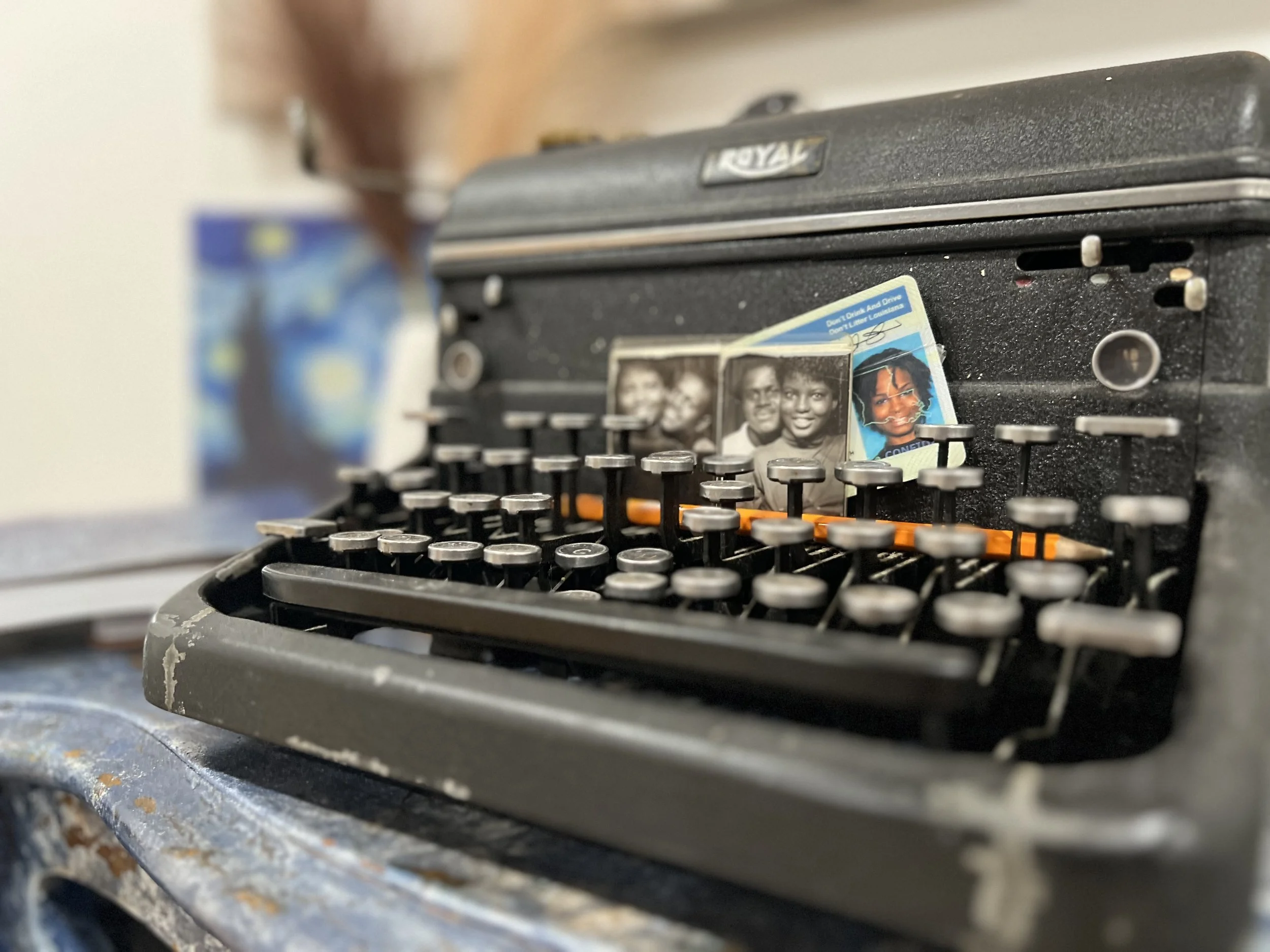 Typewriter with treasured family photographs symbolizing legacy storytelling and preserving history one story at a time.