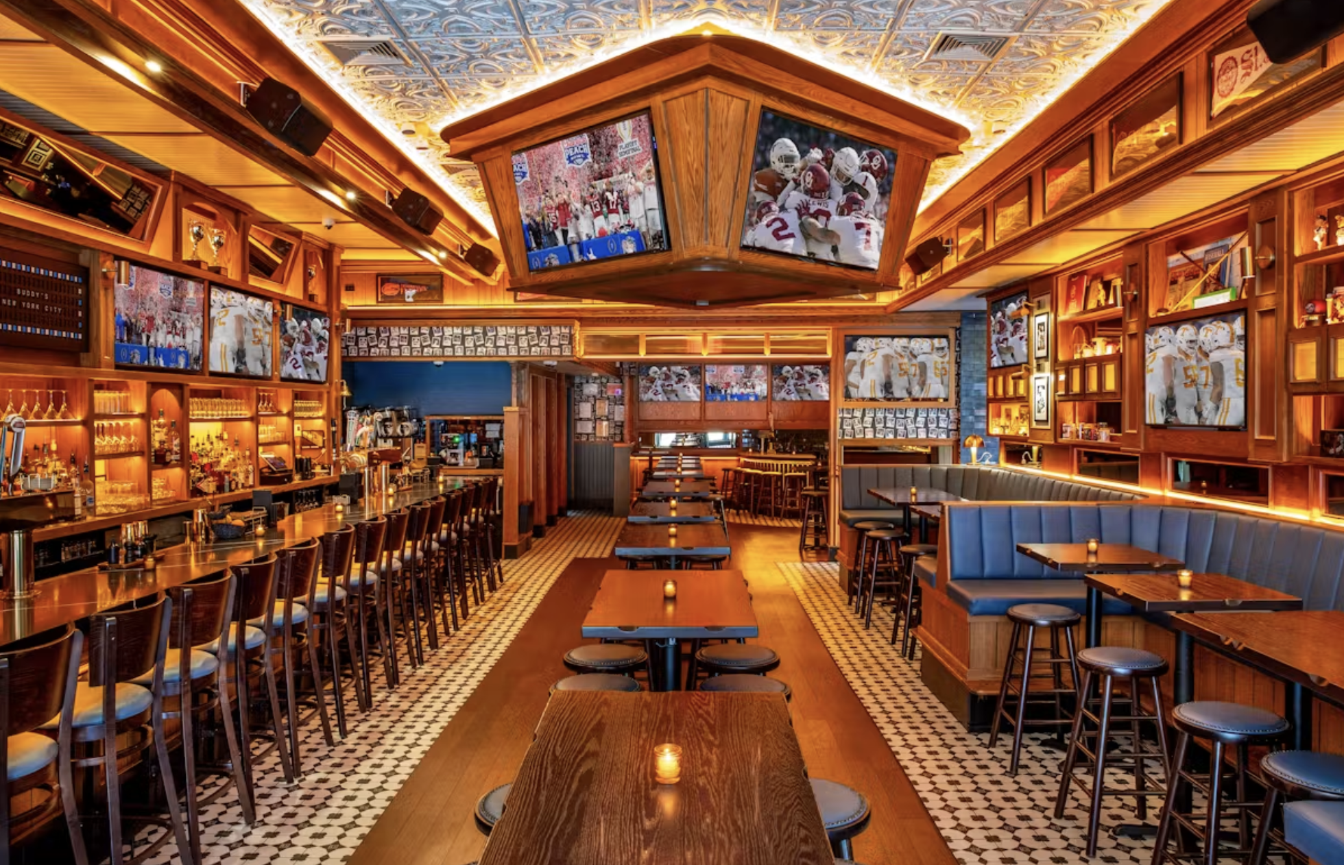 Interior of a sports bar with multiple TV screens showing football games, wooden furniture, and a bar area.