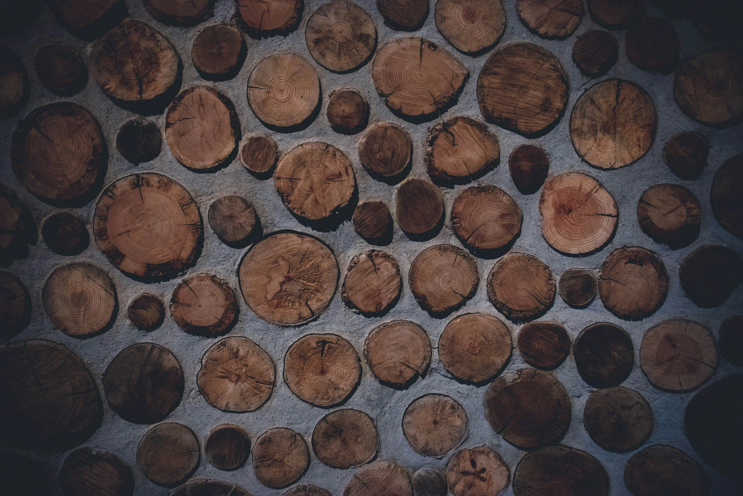 Stacked cut logs arranged in a pattern against a wall. An image for Social Media Management services offered by Maplewood Marketing.  Popular marketing services for businesses in northern Wisconsin.