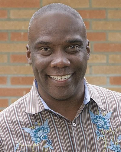 Austin Nation, Associate Professor of Nursing at Cal State Fullerton and solo theater performer, smiling portrait
