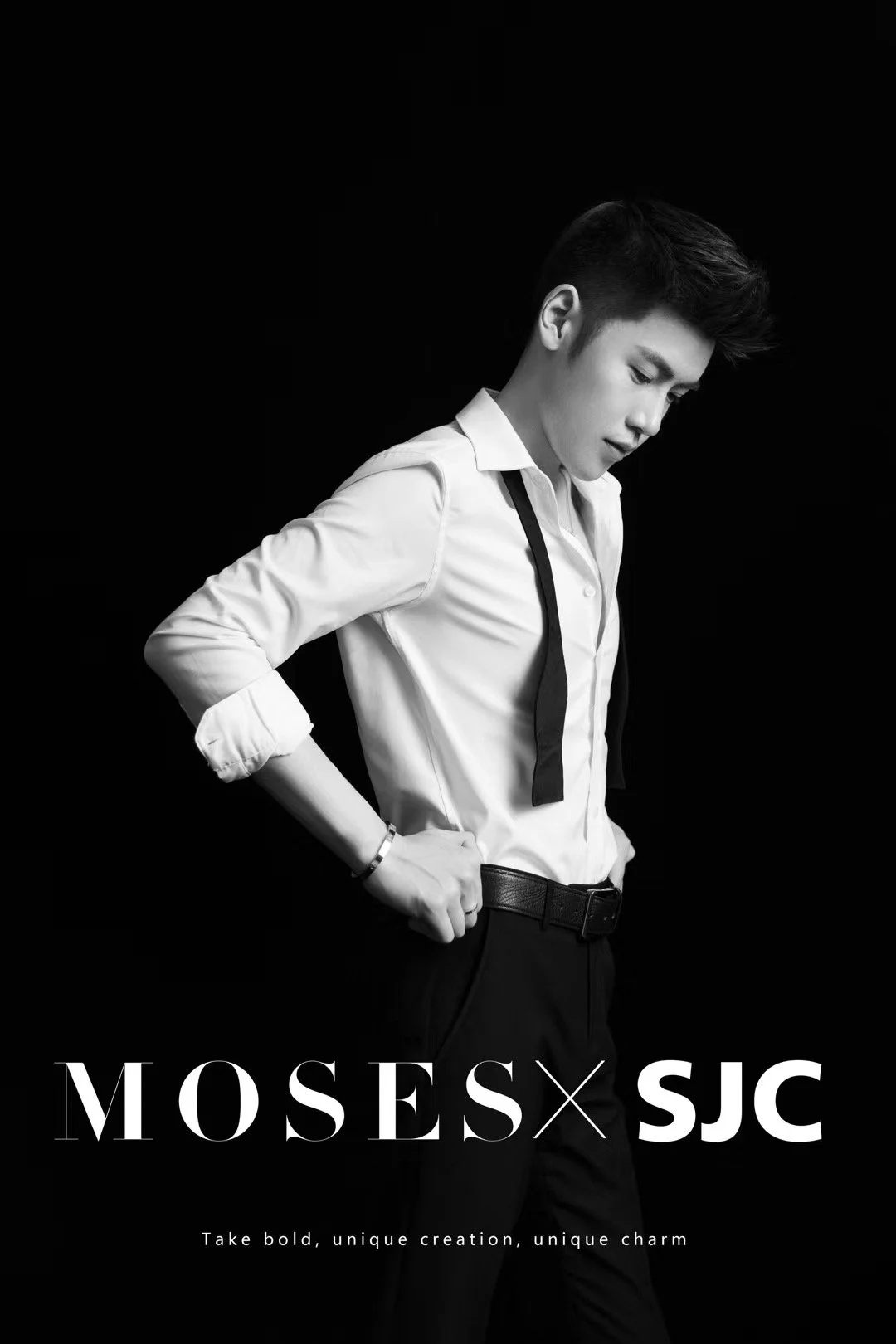 Black and white fashion advertisement featuring a young man in a white shirt and dark pants against a black background, with the text "MOSES x SJC" and the tagline "Take bold, unique creation, unique charm."