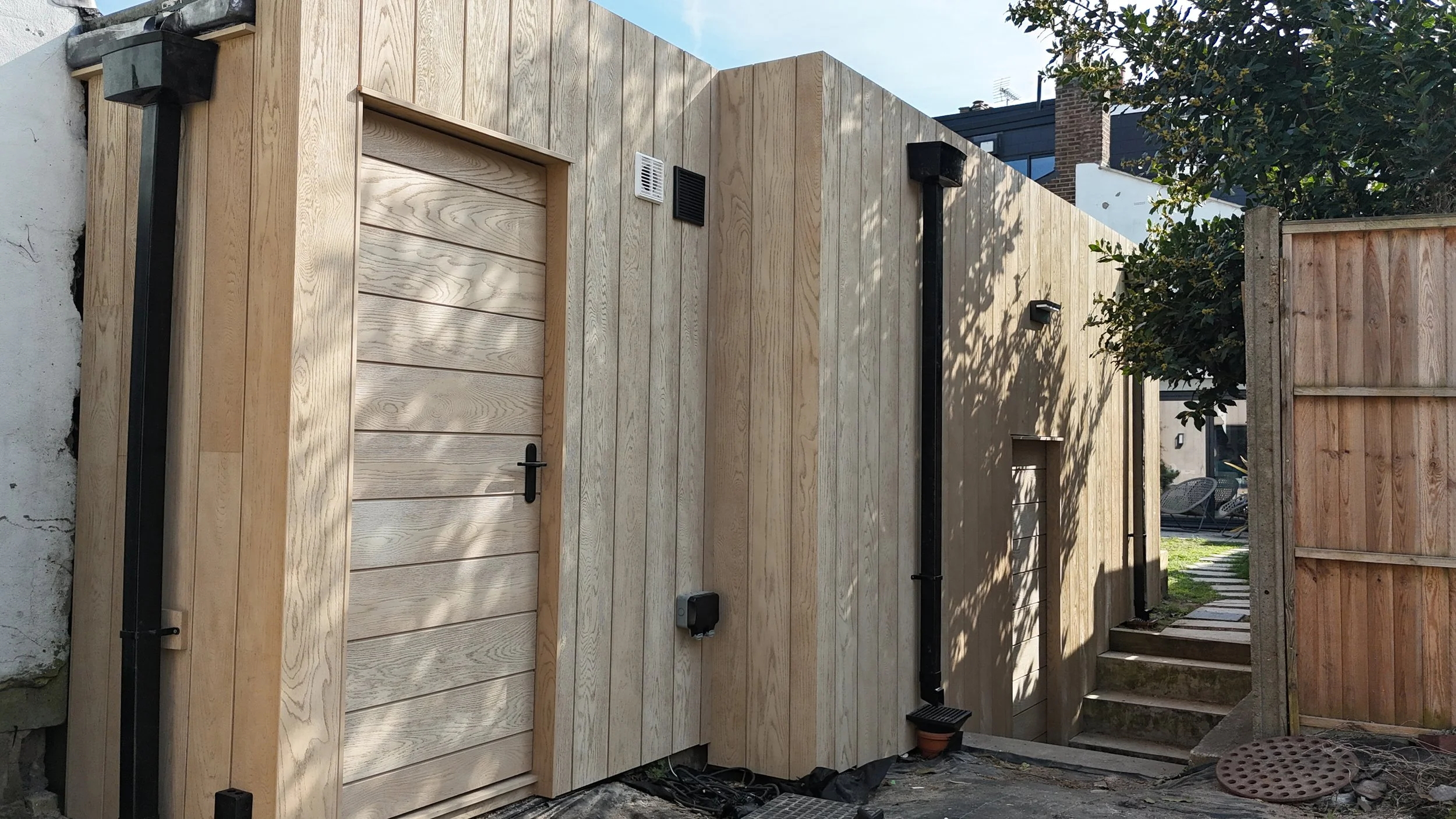 Millboard Envello Cladding in Golden Oak London.JPG