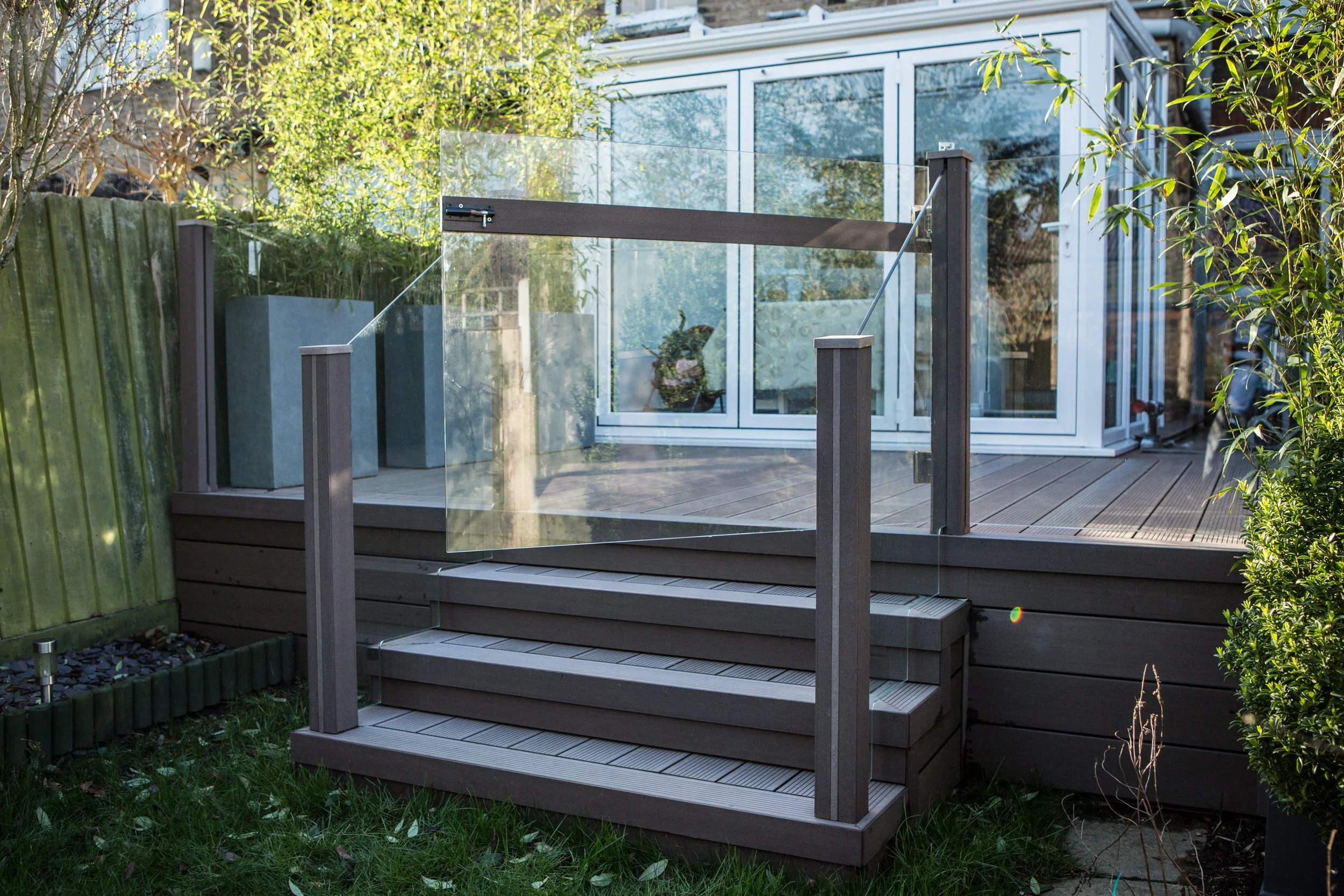 Raised Decking with Glass Balustrades in Woodford Green