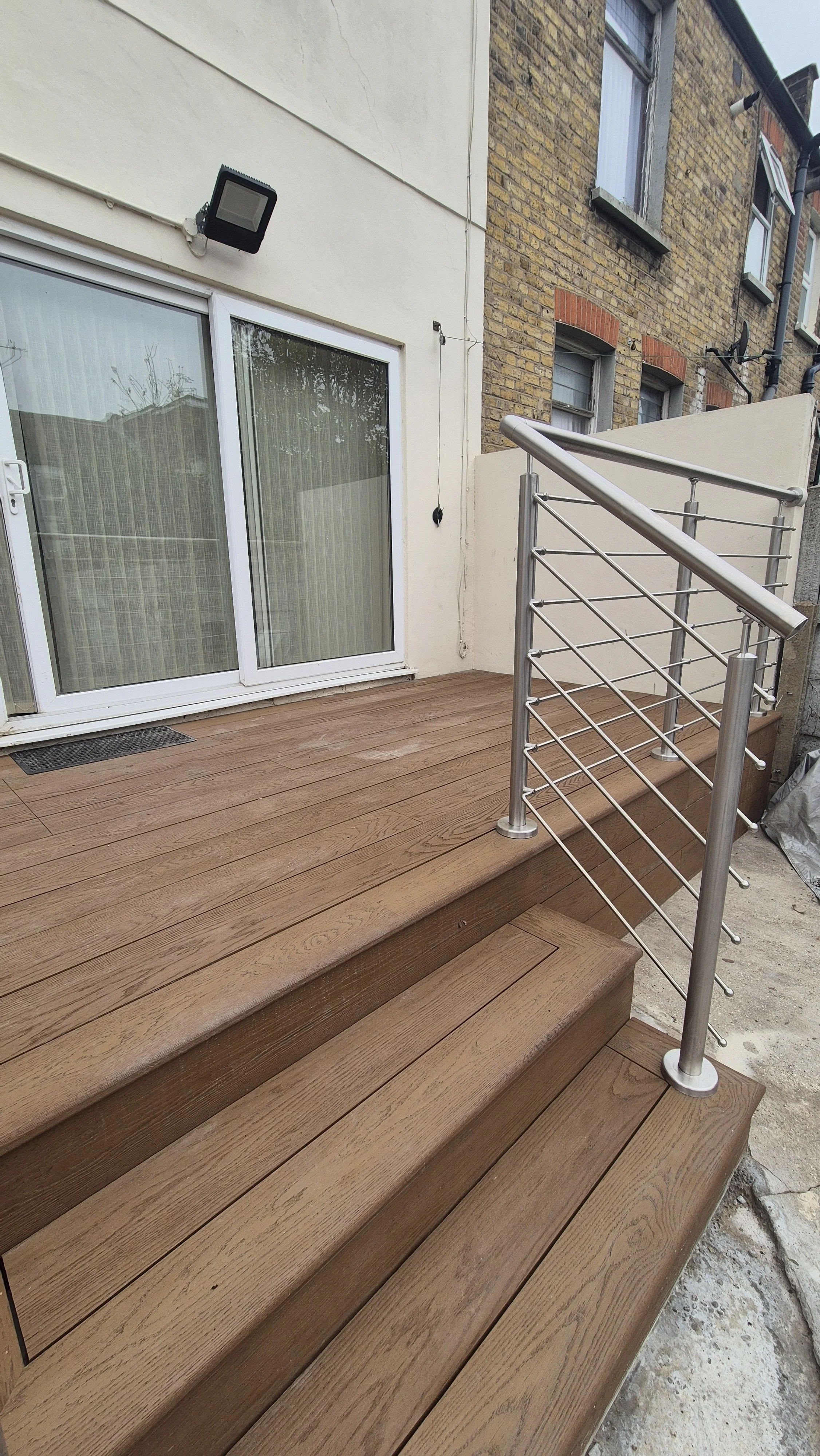Millboard Coppered Oak Decking with Stainless Steel Balustrades London.jpg