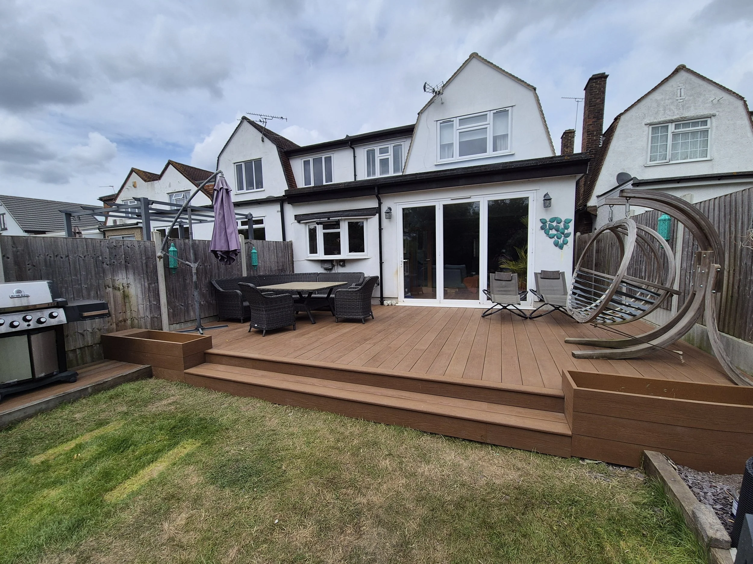 Millboard Golden Oak Decking with Integrated Planters & BBQ Area – Romford, London