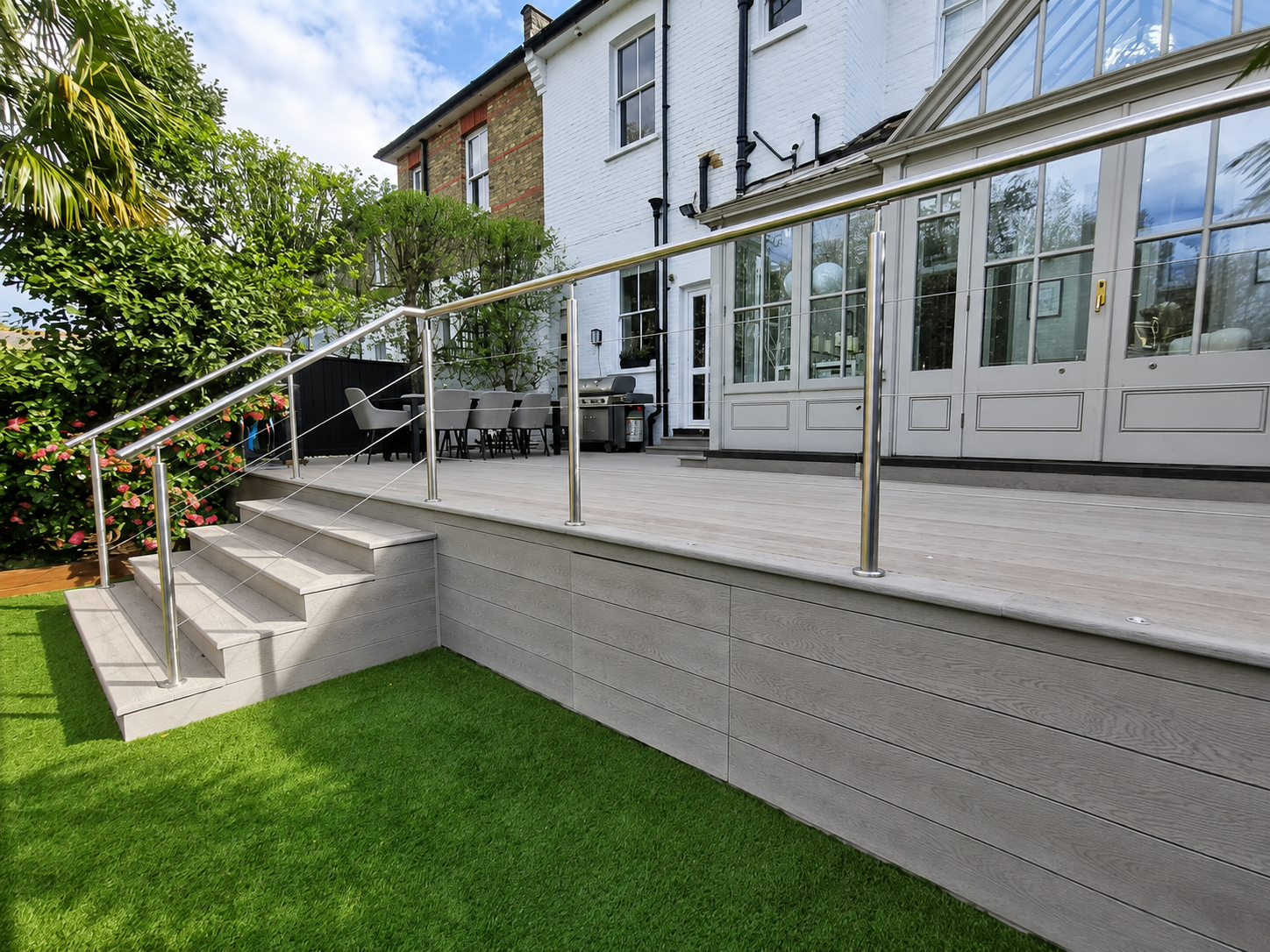 Curved composite decking with metal railings Essex