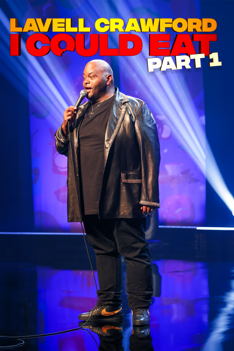 Comedian Lavell Crawford performing on stage with a microphone, wearing a black leather jacket and black pants, with colorful stage lighting and a background screen displaying text. "Lavell Crawford: I Could Eat"