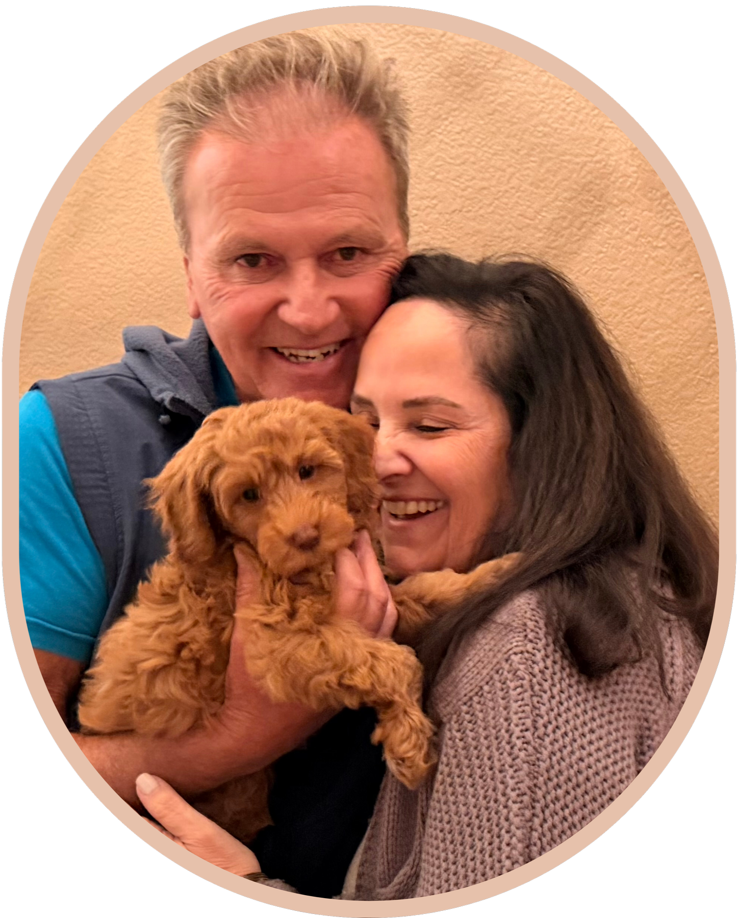 Couple holding Goldendoodle puppy