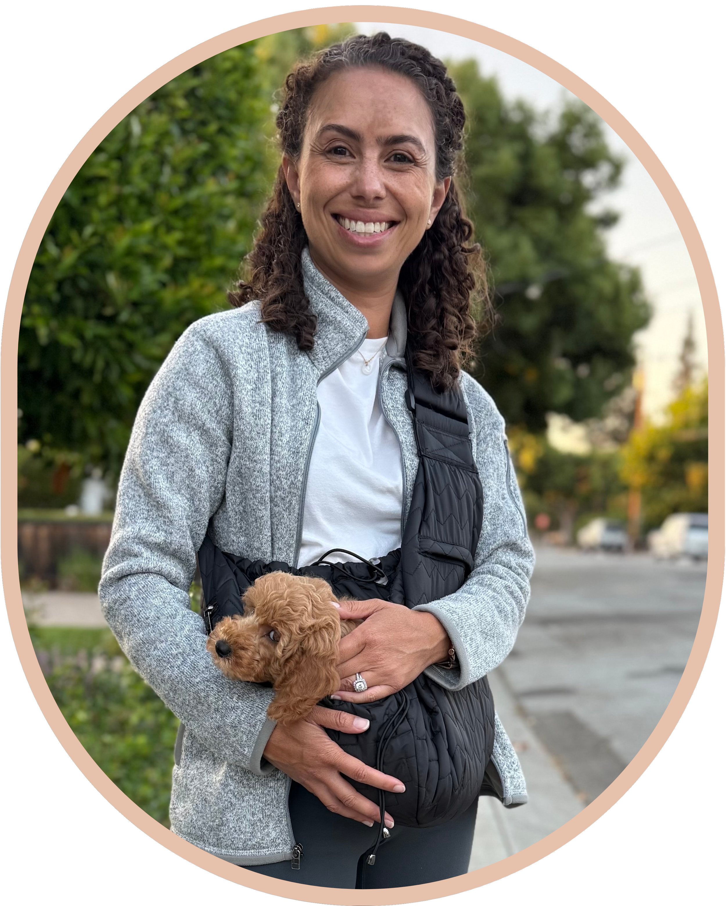 Sarah with Goldendoodle puppy in a sling on a walk