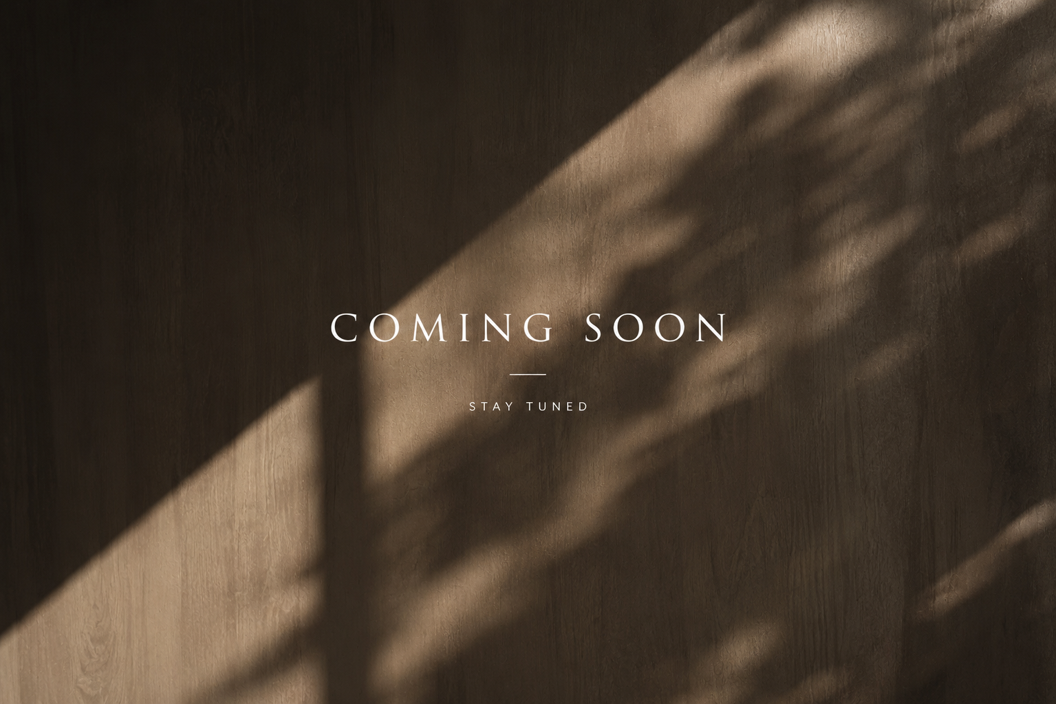 A wooden surface with shadows and text that reads 'COMING SOON - STAY TUNED'.