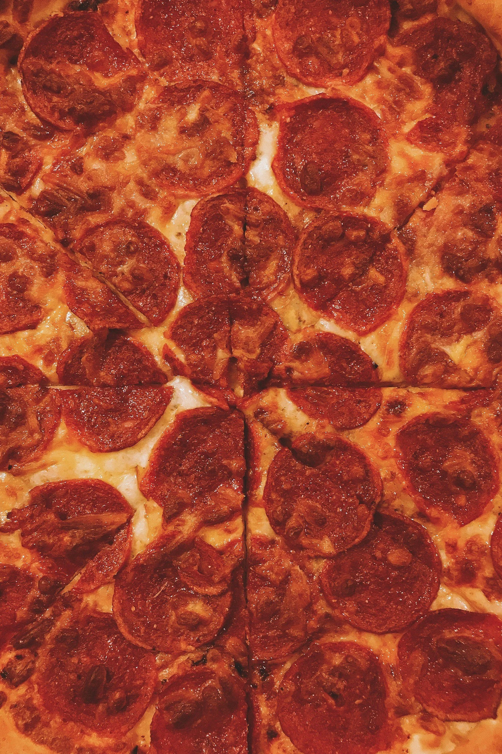 Close-up of a pepperoni pizza showing multiple slices of pepperoni and melted cheese.