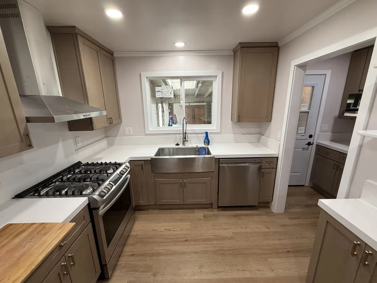 a brand new kitchen with a window above the sink
