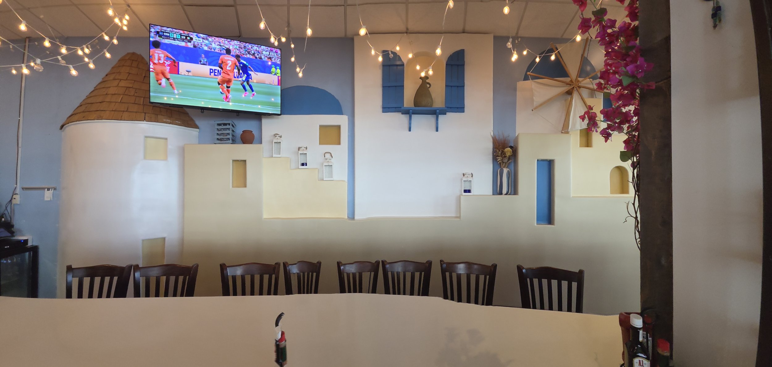 Back wall of the restaurant with cutouts of the Greek landscape.