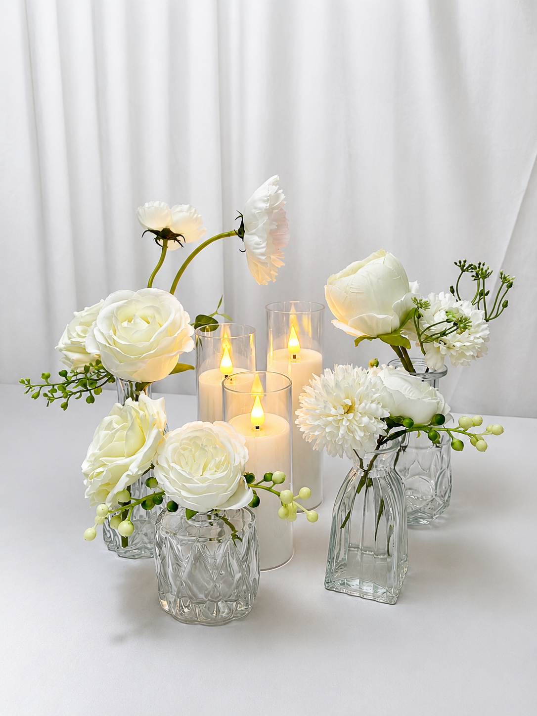 Set of three (3) bud vases, each styled with faux floral stems. 
Rental Price: $5 per set

