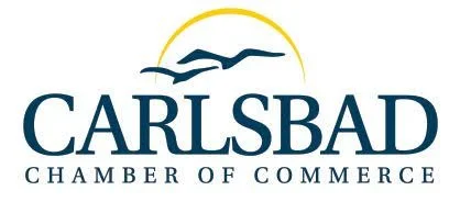 Logo of the Carlsbad Chamber of Commerce with a stylized bird and sun in blue and yellow colors.