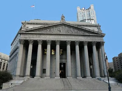 The United States Supreme Court building with tall columns and a flag on top, located in Washington, D.C.